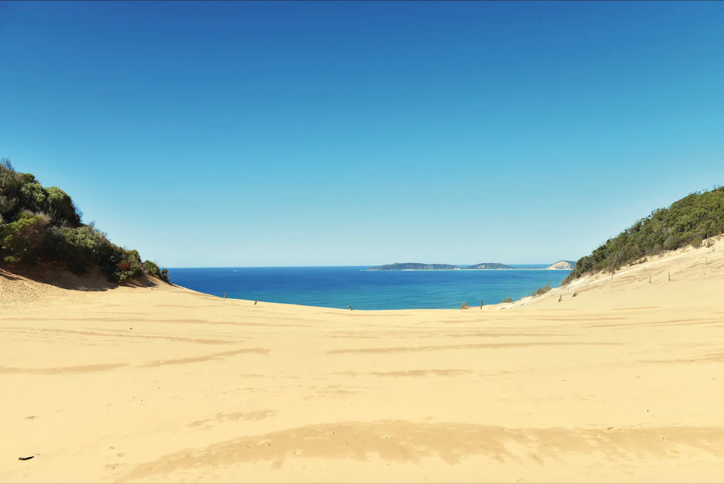 Carlo Sandblow sand dune with Double Island Point in distance.