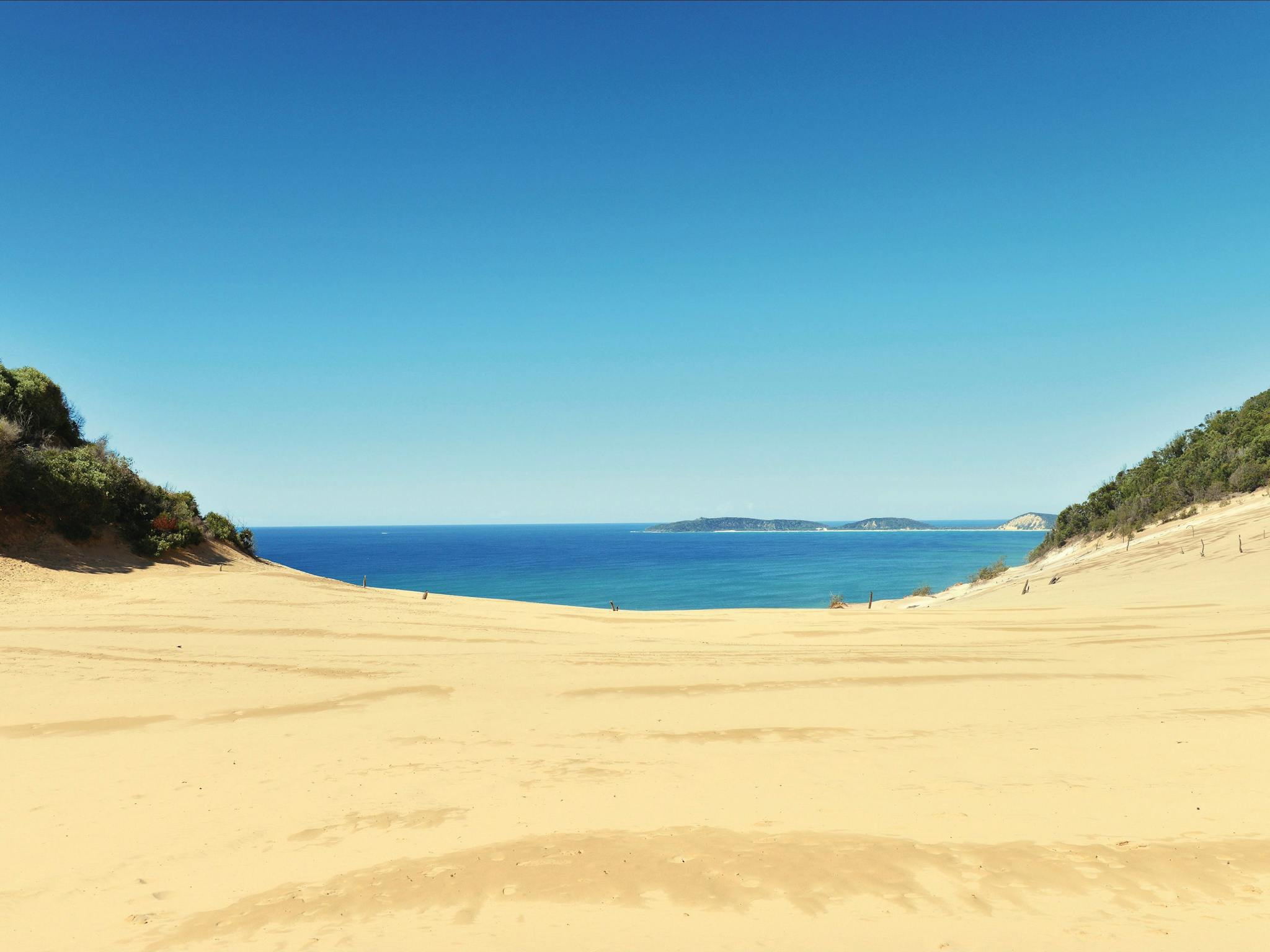 Carlo Sandblow sand dune with Double Island Point in distance.