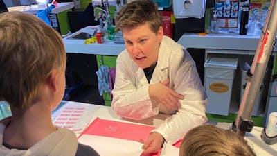 Forensic AFP personnel showing forensic science to two young boys