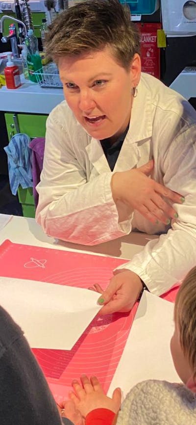 Forensic AFP personnel showing forensic science to two young boys