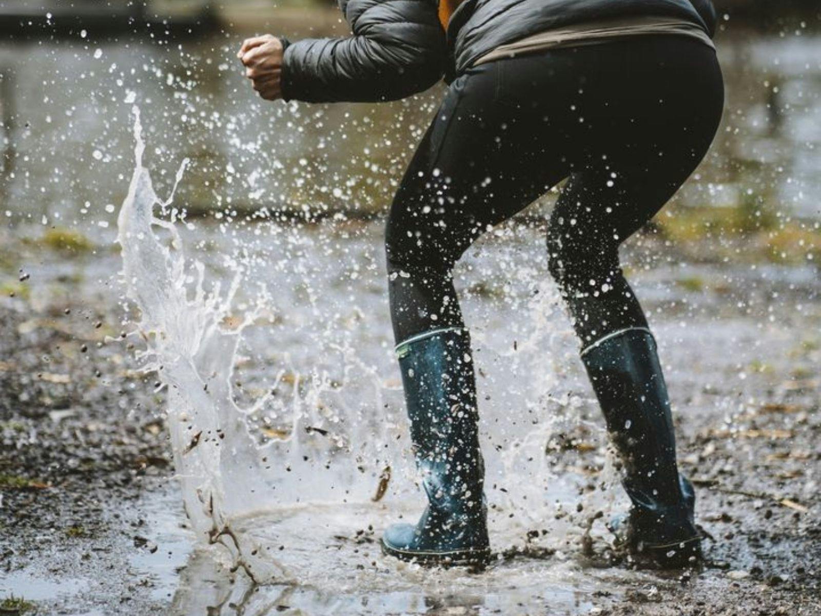 Person jumping in puddle