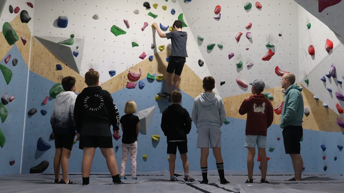 A group of kids going through their saftey orientation at Wall Walkers Bouldering.