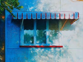 Painting of the side of a fibro house with window and awning