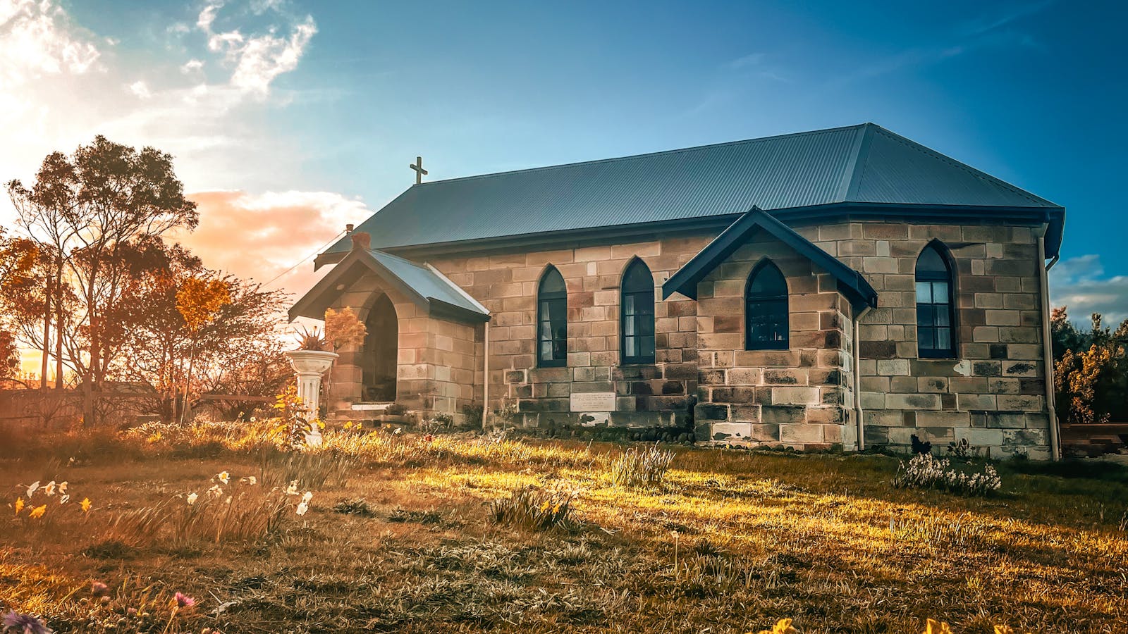 front sandstone facade and meadow