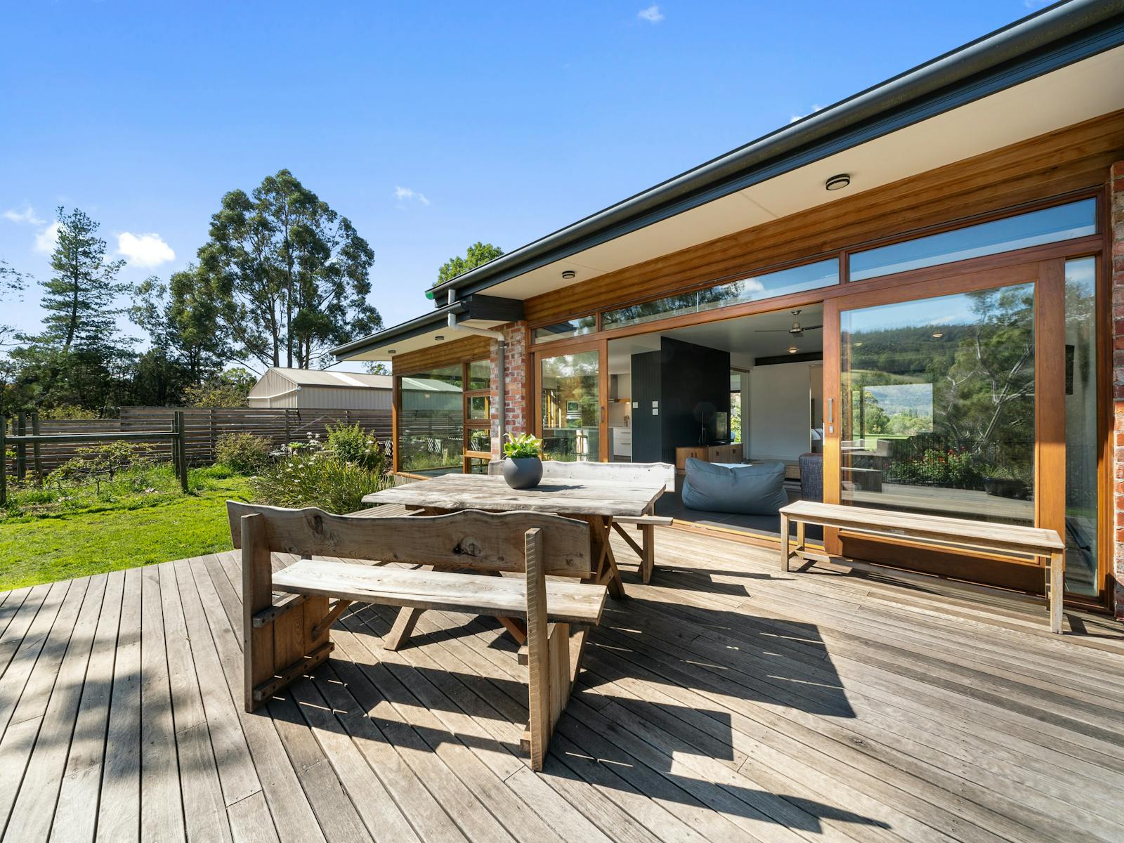 The main deck adjoining the living room provides outdoor dining and views over the river and valley