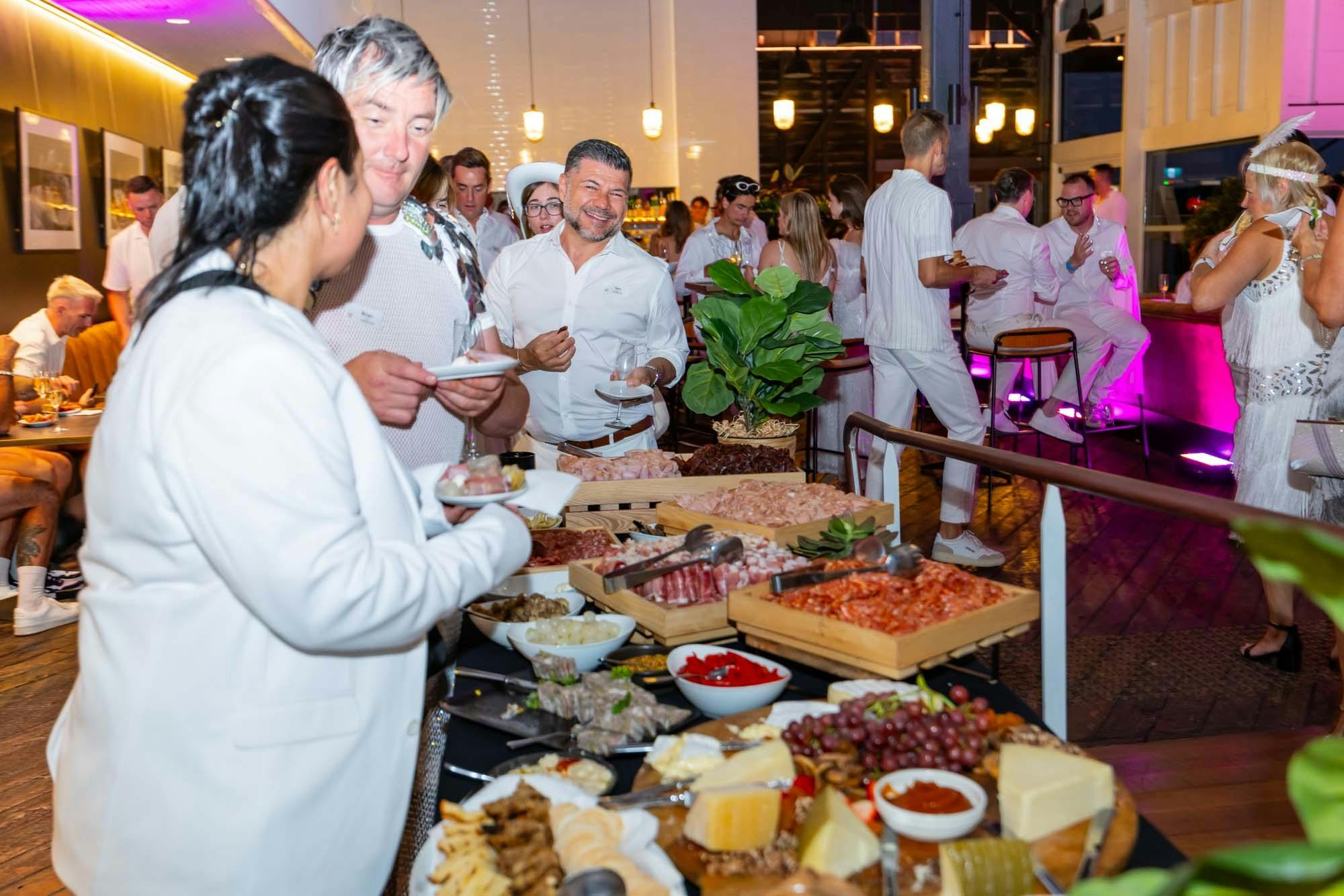 Charcuterie and grazing table with guests at The Wharf.