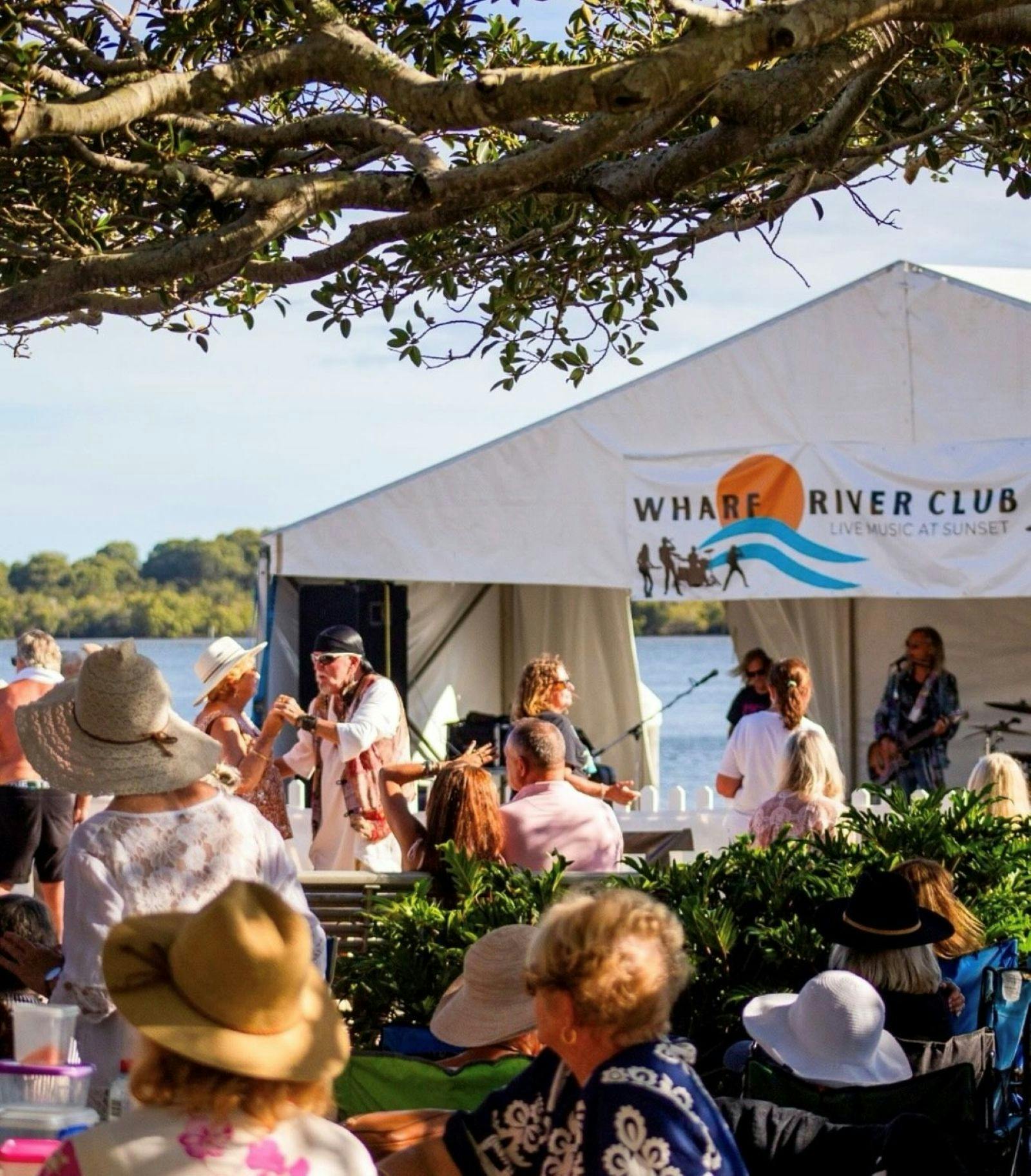 people dancing in front of musicians playing on wharf