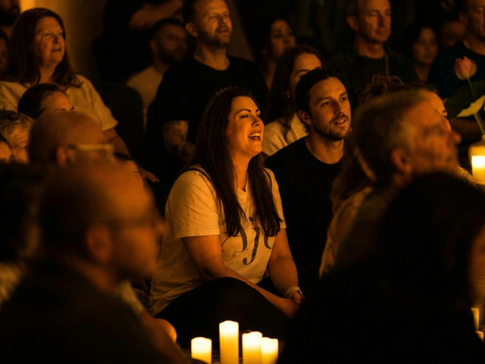 Woman seated in a crowd smiling
