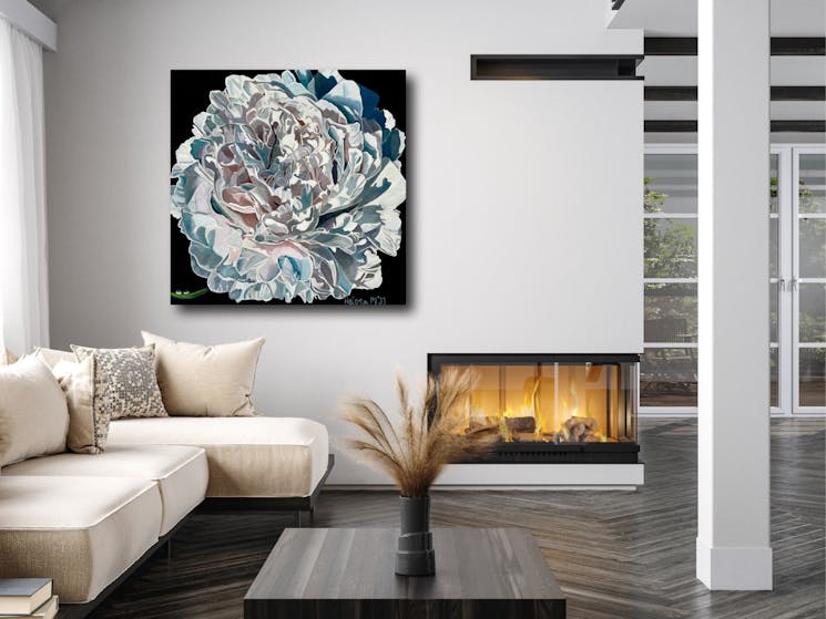 Floral artwork hanging on the wall with lounge and fire burning