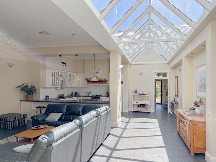 Large living area with a glass atrium roof