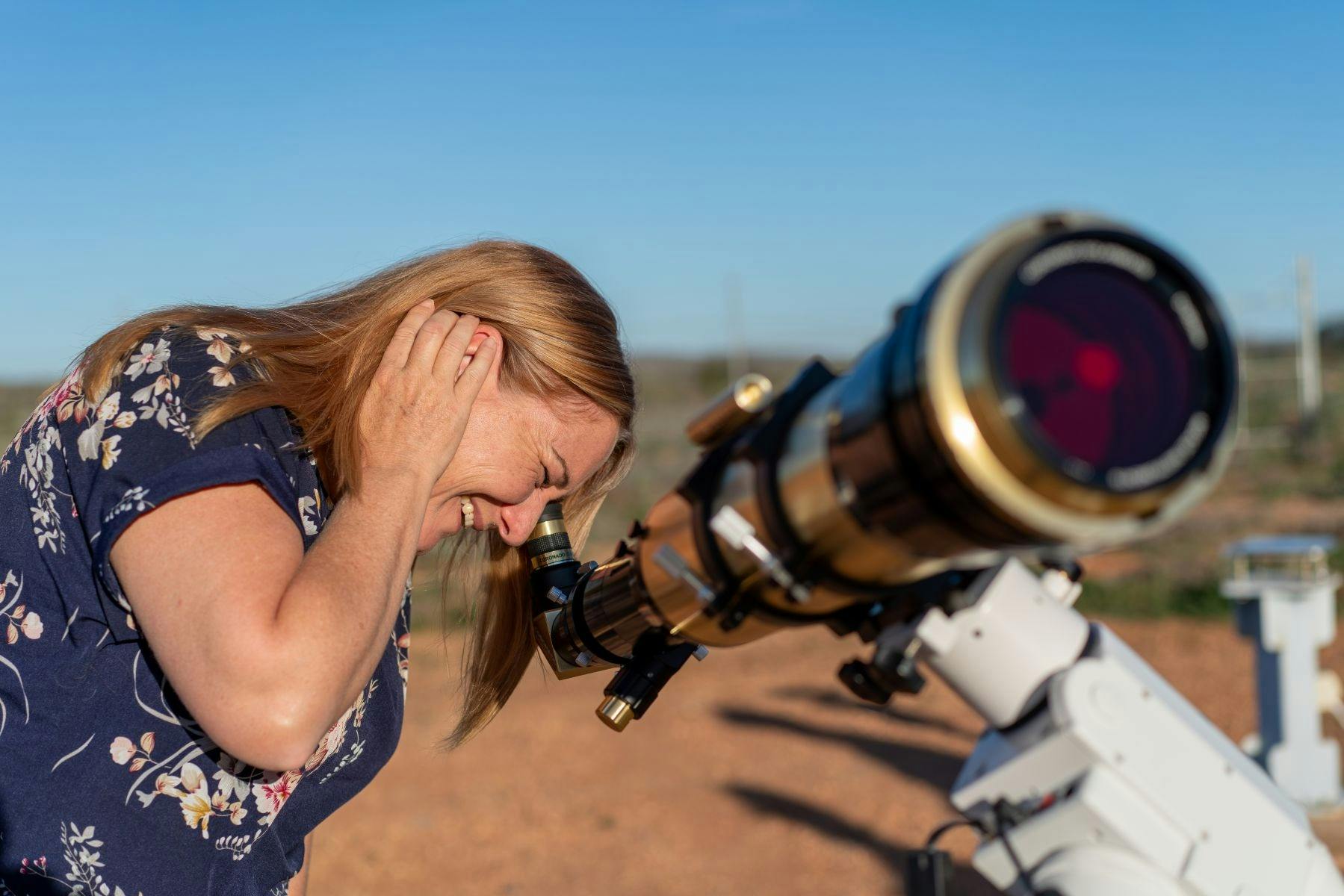 Woman-looks-into-telescope-at-Outback-Astronomy