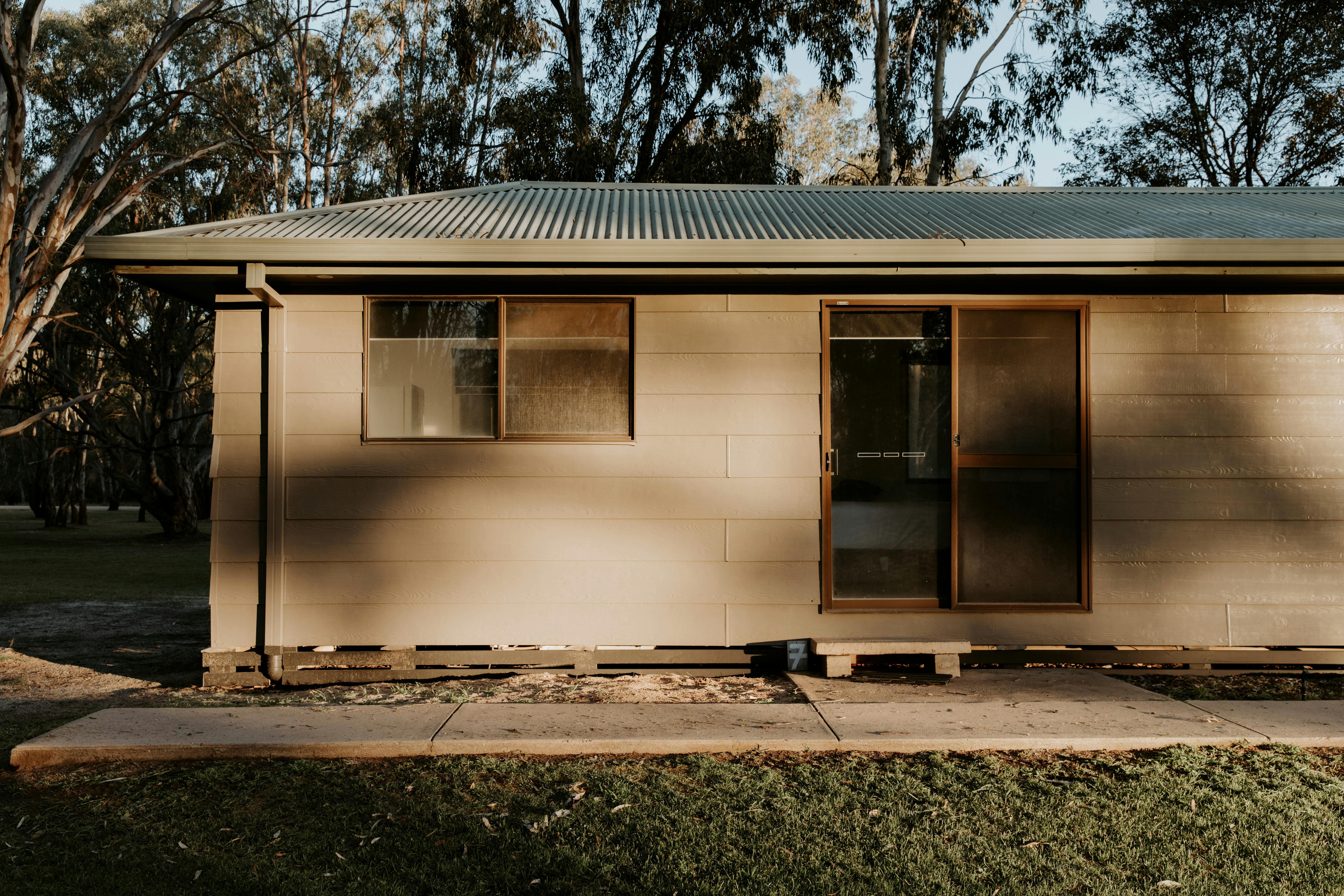 Golden hour light hitting the outside of the Deluxe View Cabins atThe Paddock at Ulupna