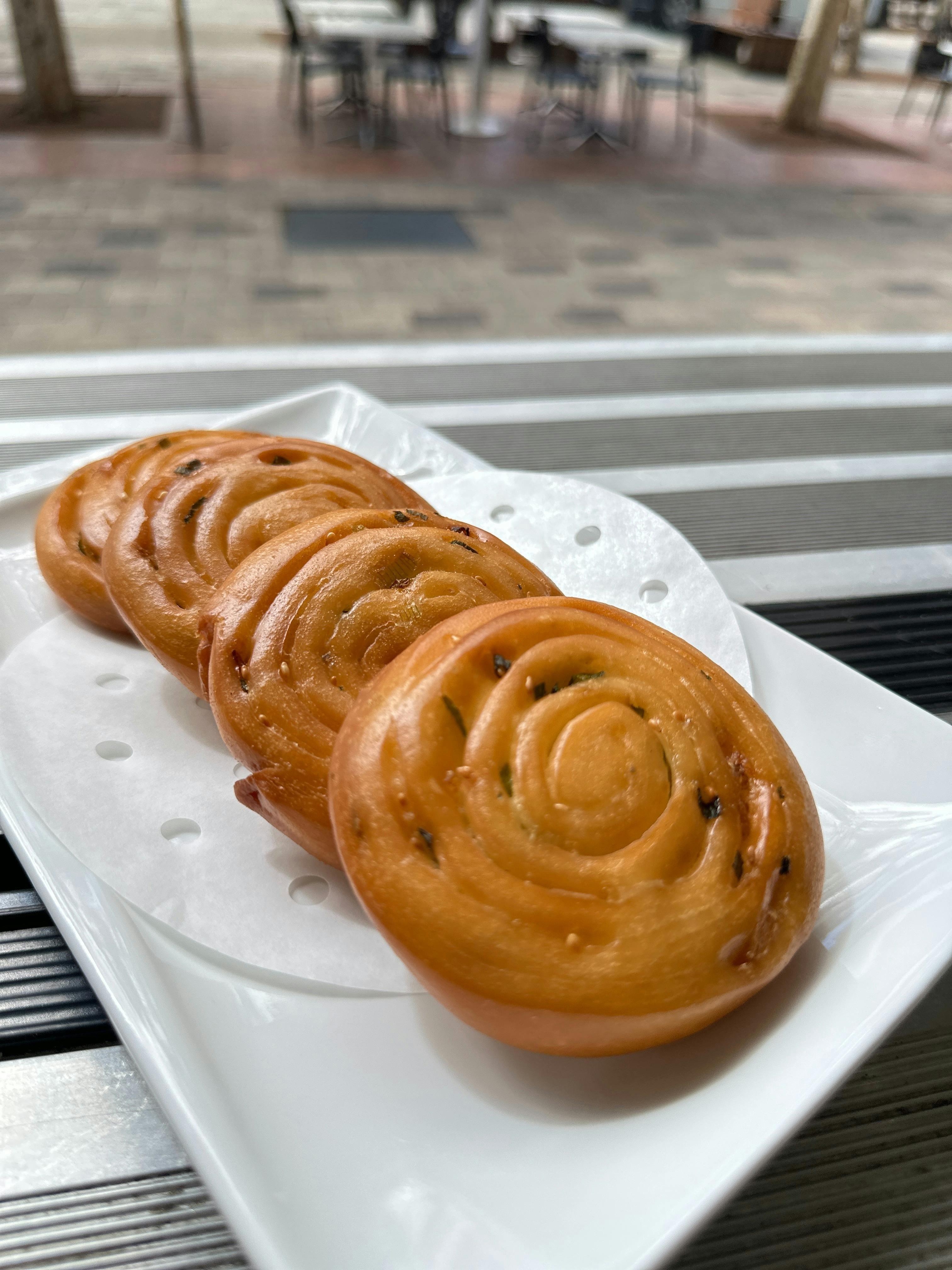 Golden fried scallion pancakes swirled with green onions and sesame seeds, served hot.
