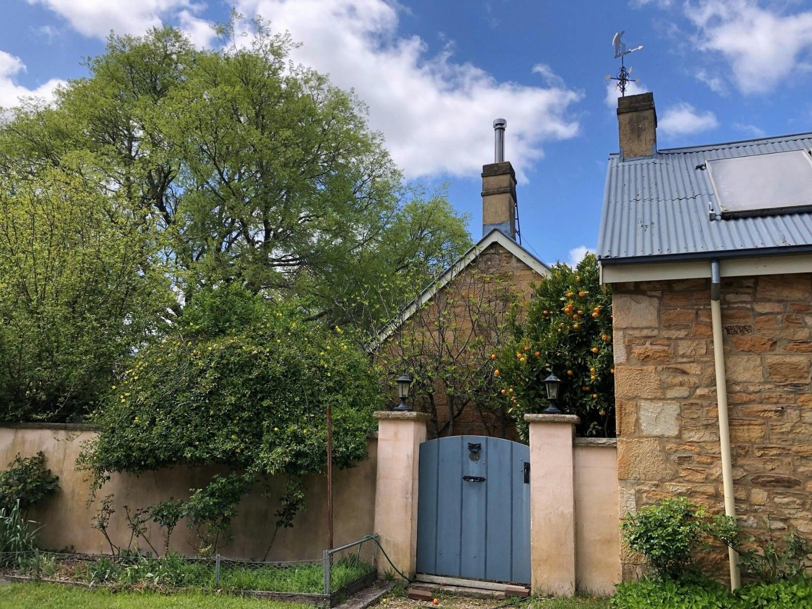 Historic walls and gates with fruits from the garden spilling over