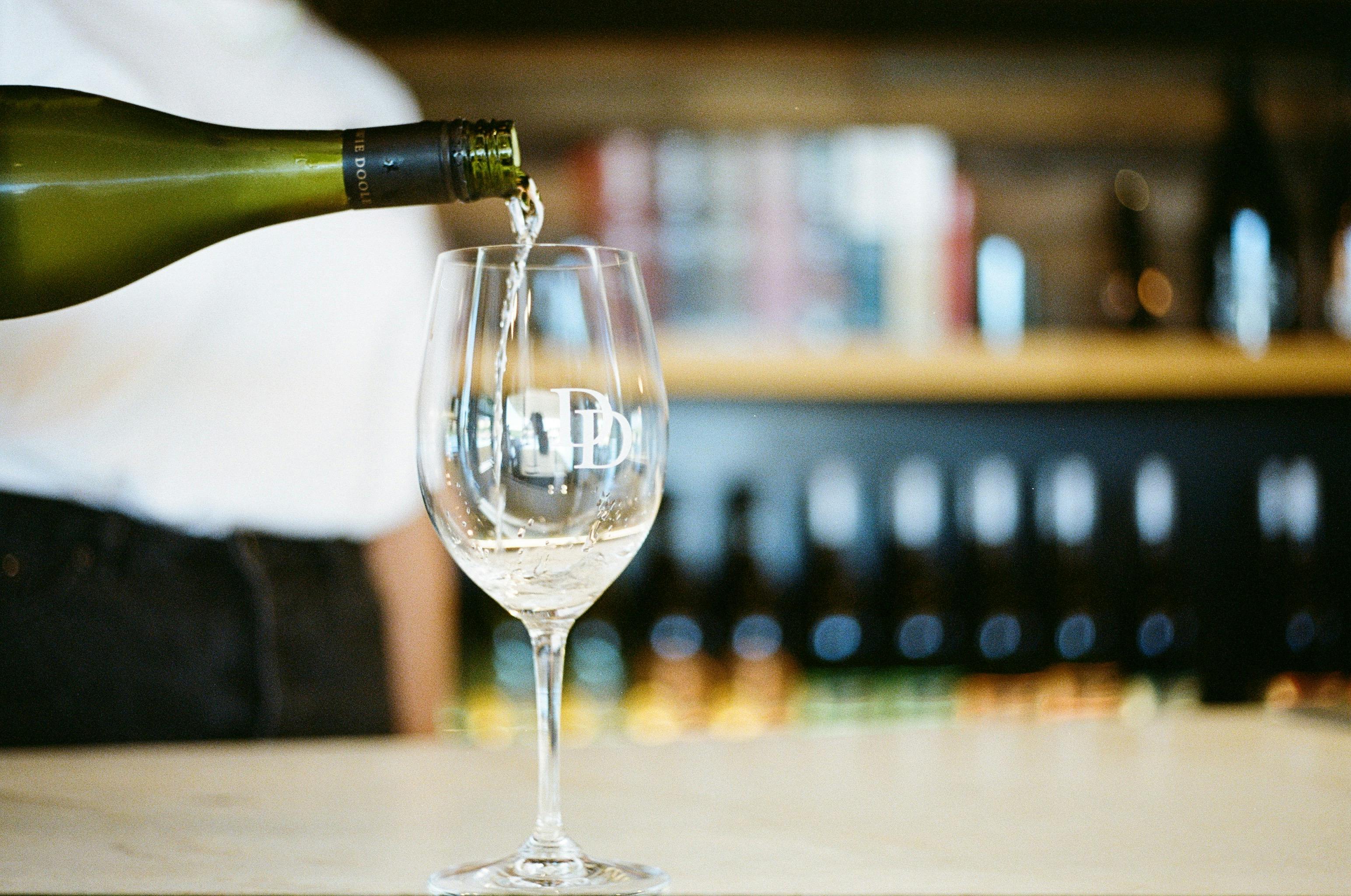 Wine being poured for a hosted flight.