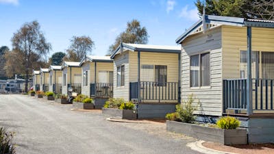 Row of well-maintained cabins at Southside Village, ideal for a peaceful and convenient stay.