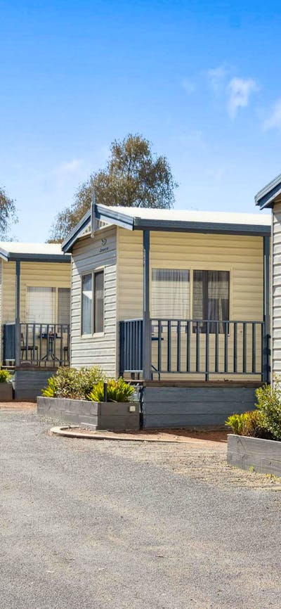 Row of well-maintained cabins at Southside Village, ideal for a peaceful and convenient stay.