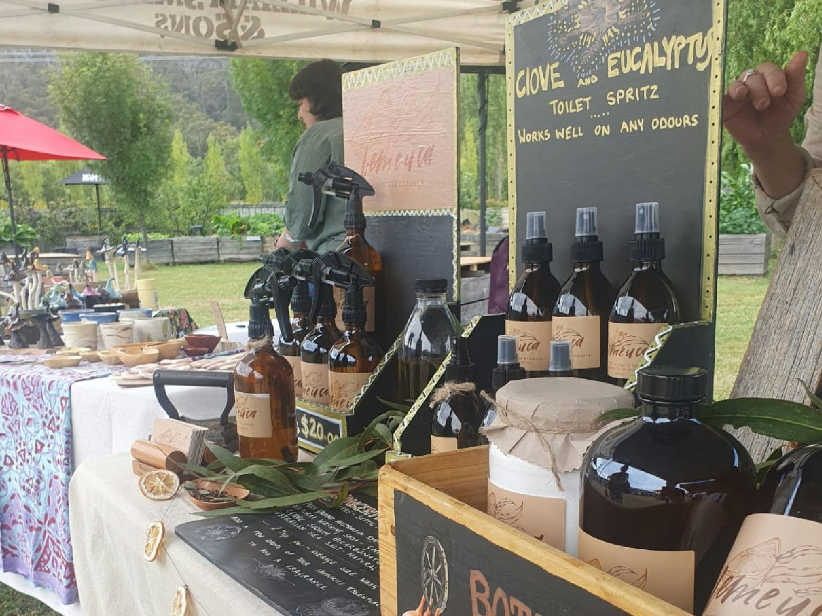 A side view of an organic cleaning product stall with bottle in the foreground.
