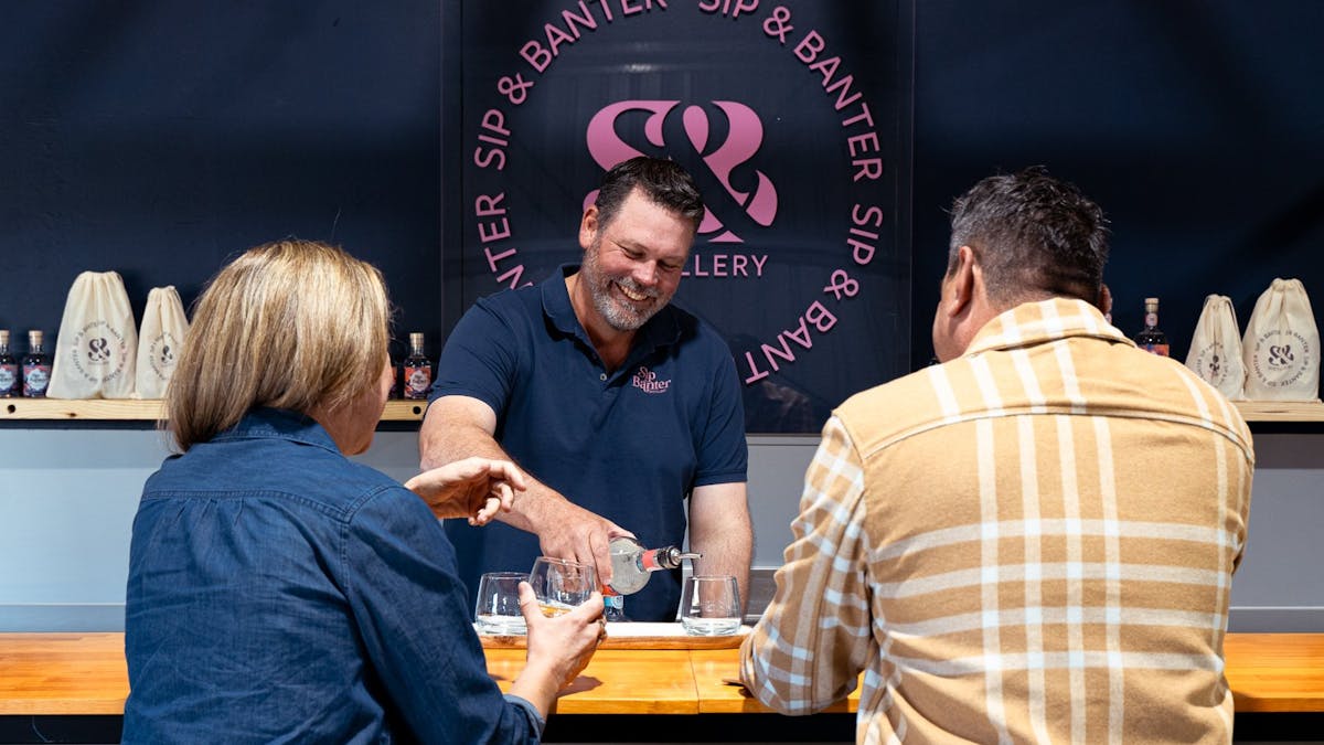People sitting at a bar drinking gin
