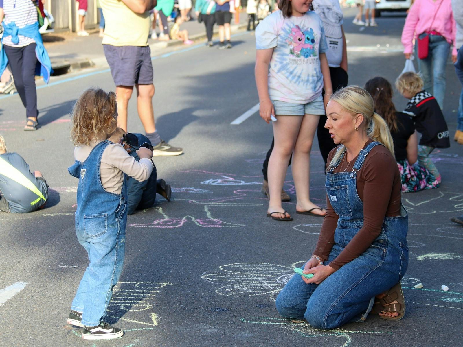 A group of kids enjoying the chalk the road competition.