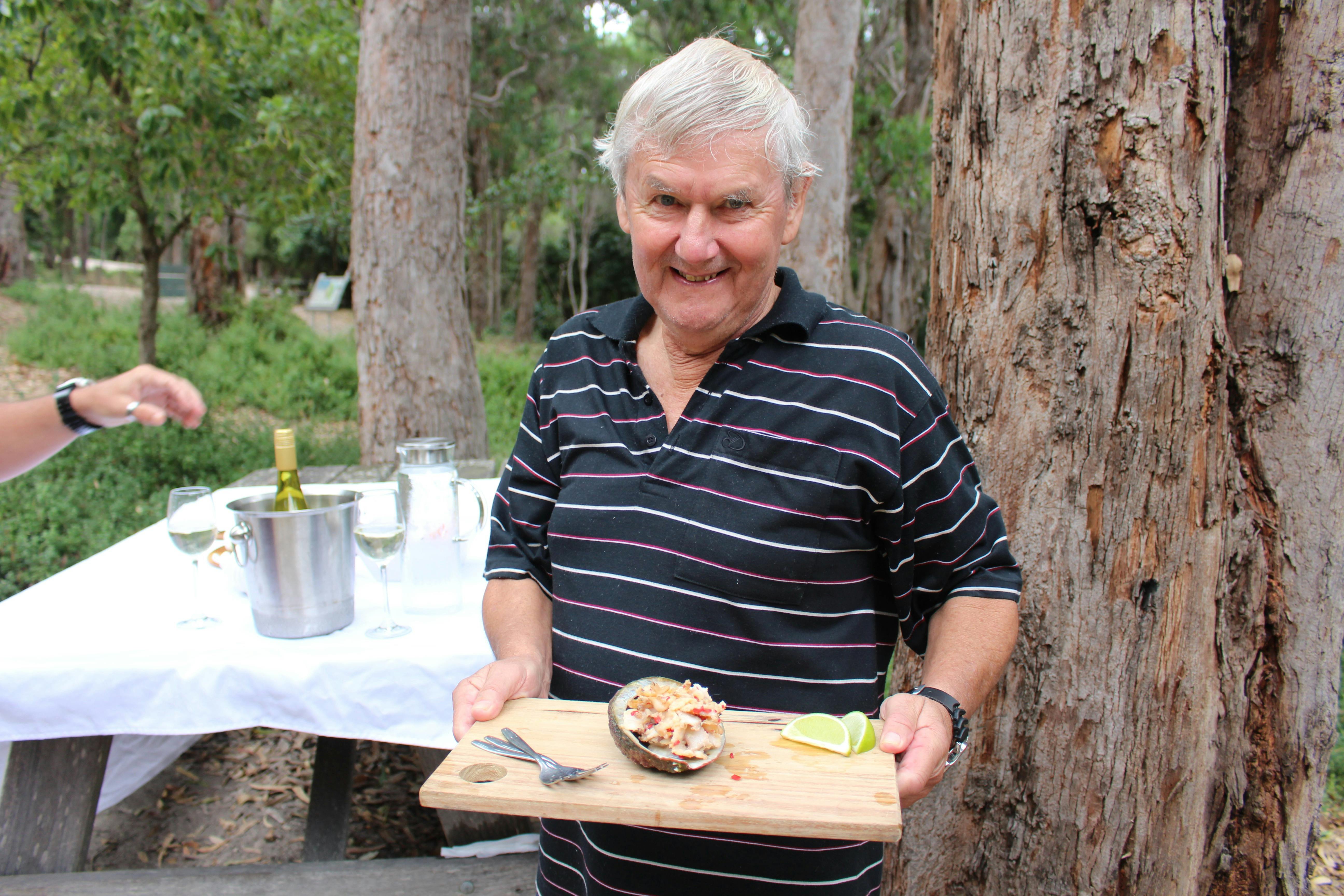 Guest holding freshly prepared abalone collected moments beforehand.