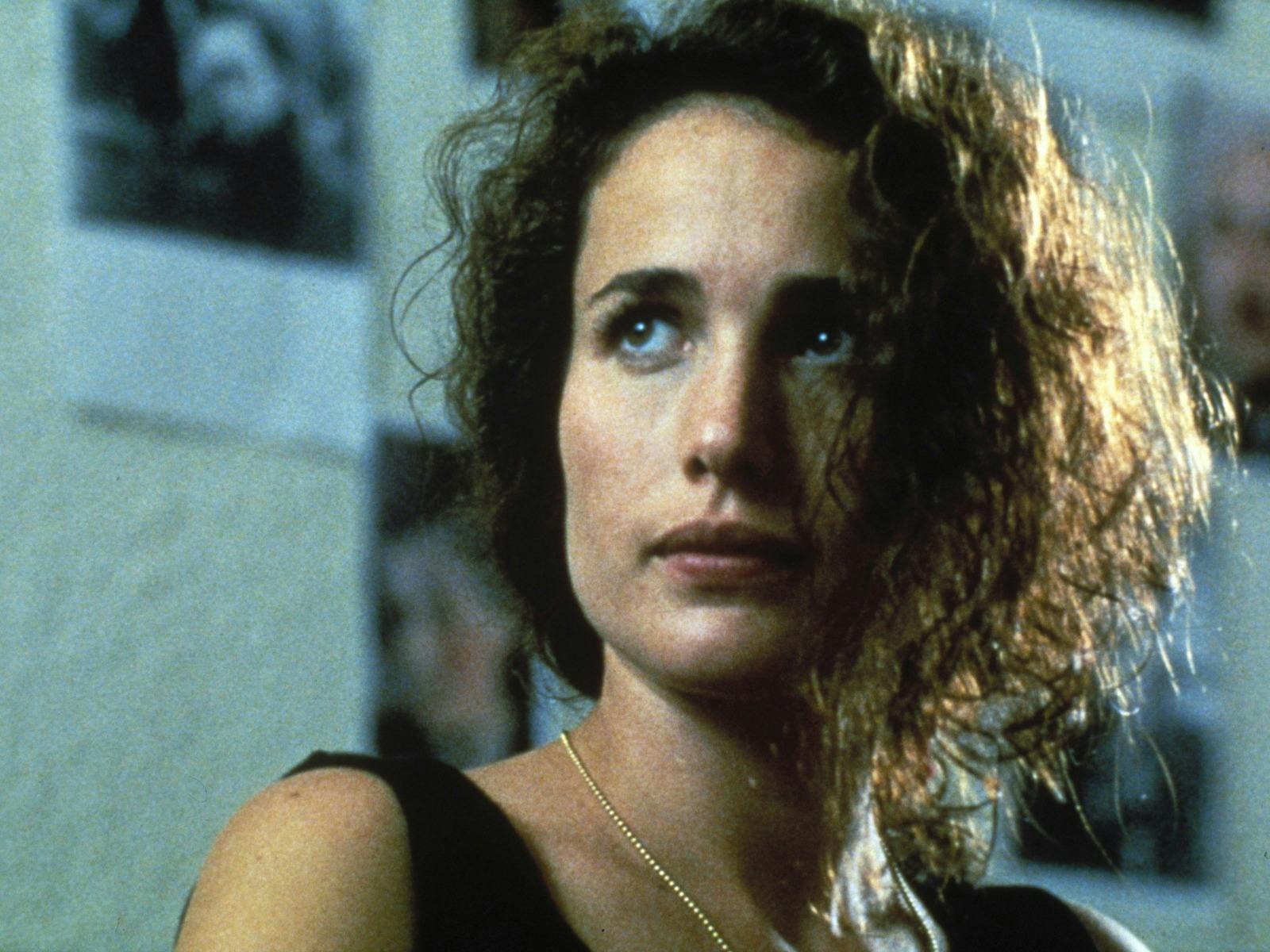 Woman with disheveled hair looking past the camera
