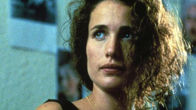 Woman with disheveled hair looking past the camera
