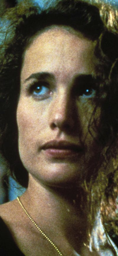 Woman with disheveled hair looking past the camera