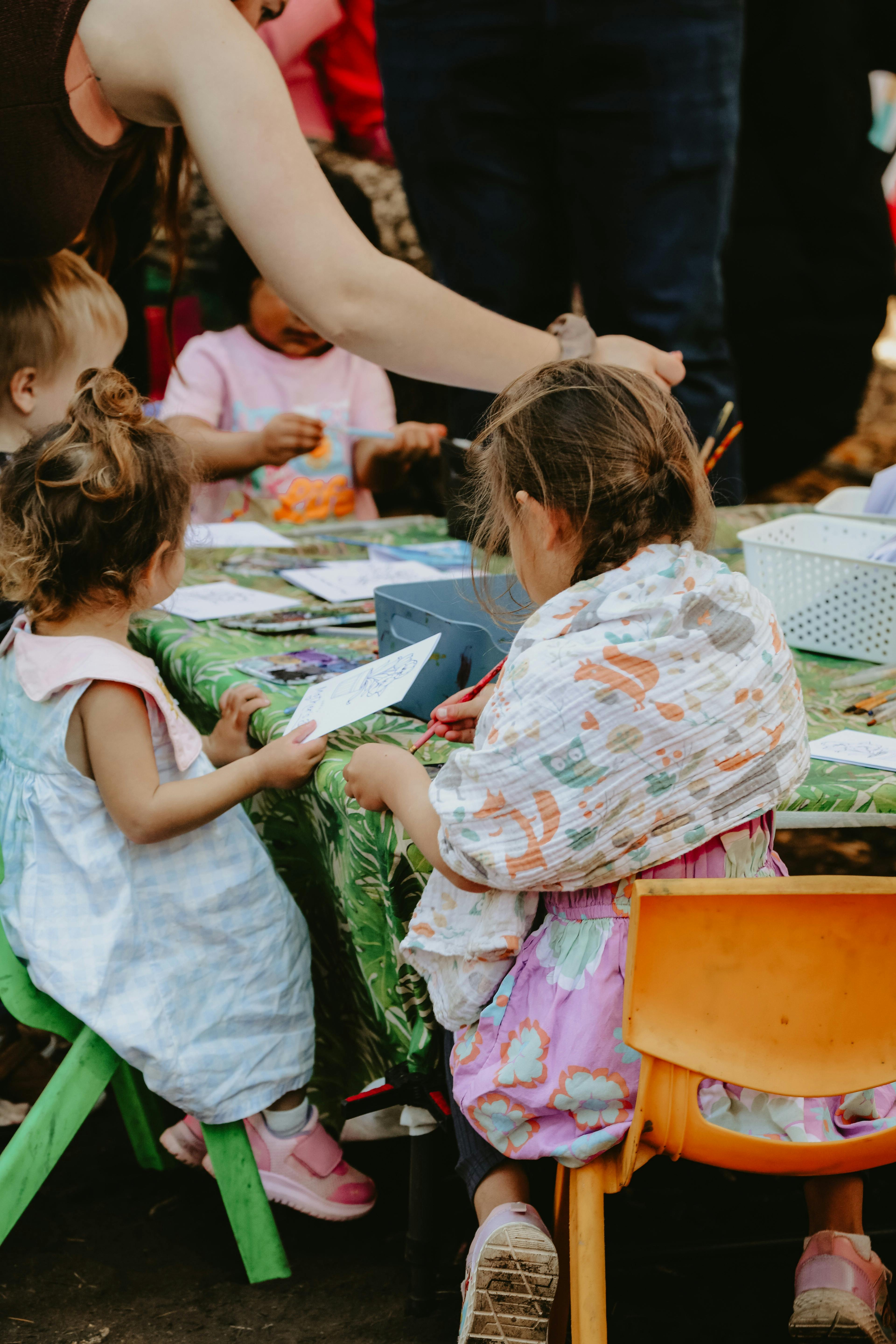 Children sitting around a table doing colouring in activities