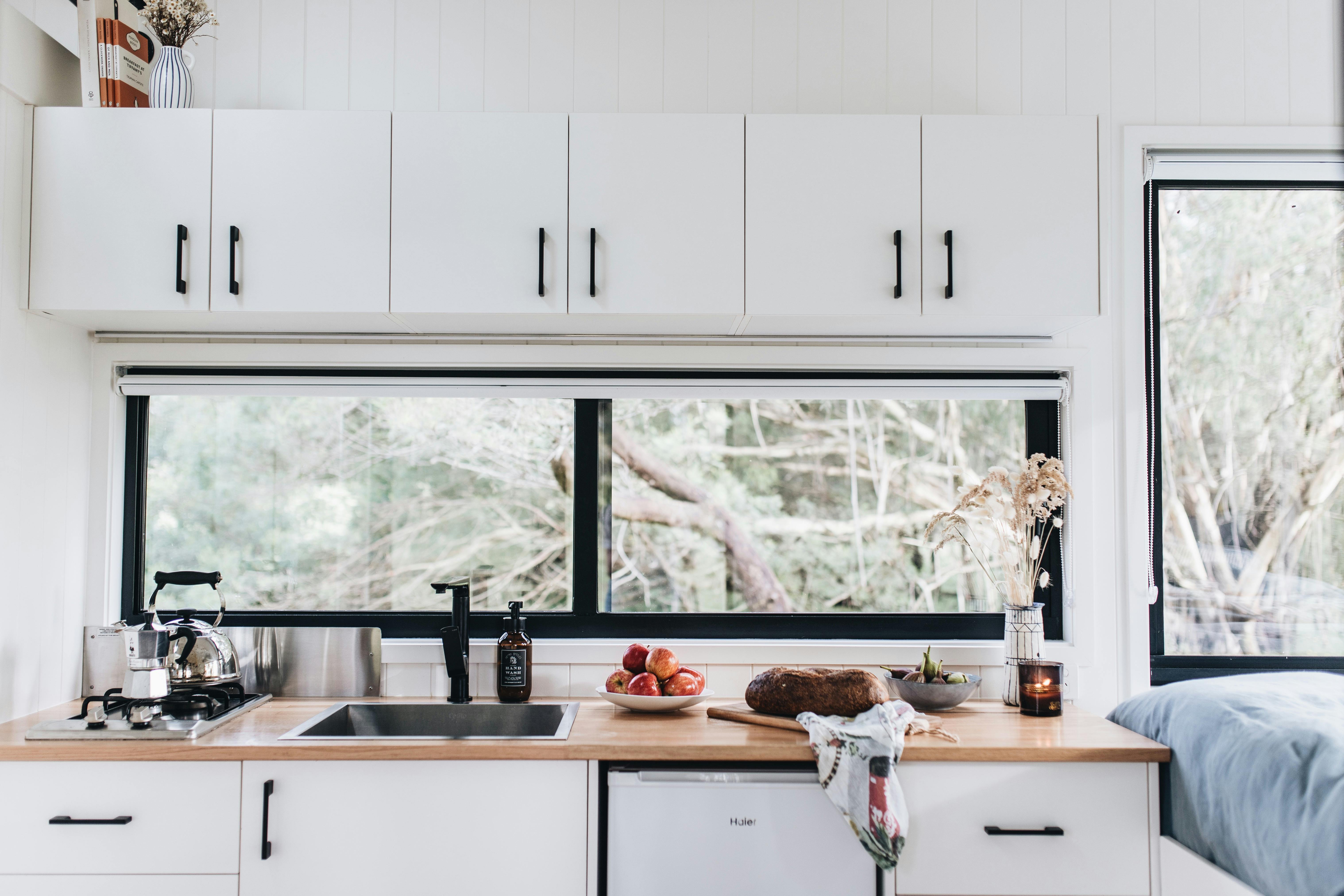Kitchen with sink, stove top and fridge