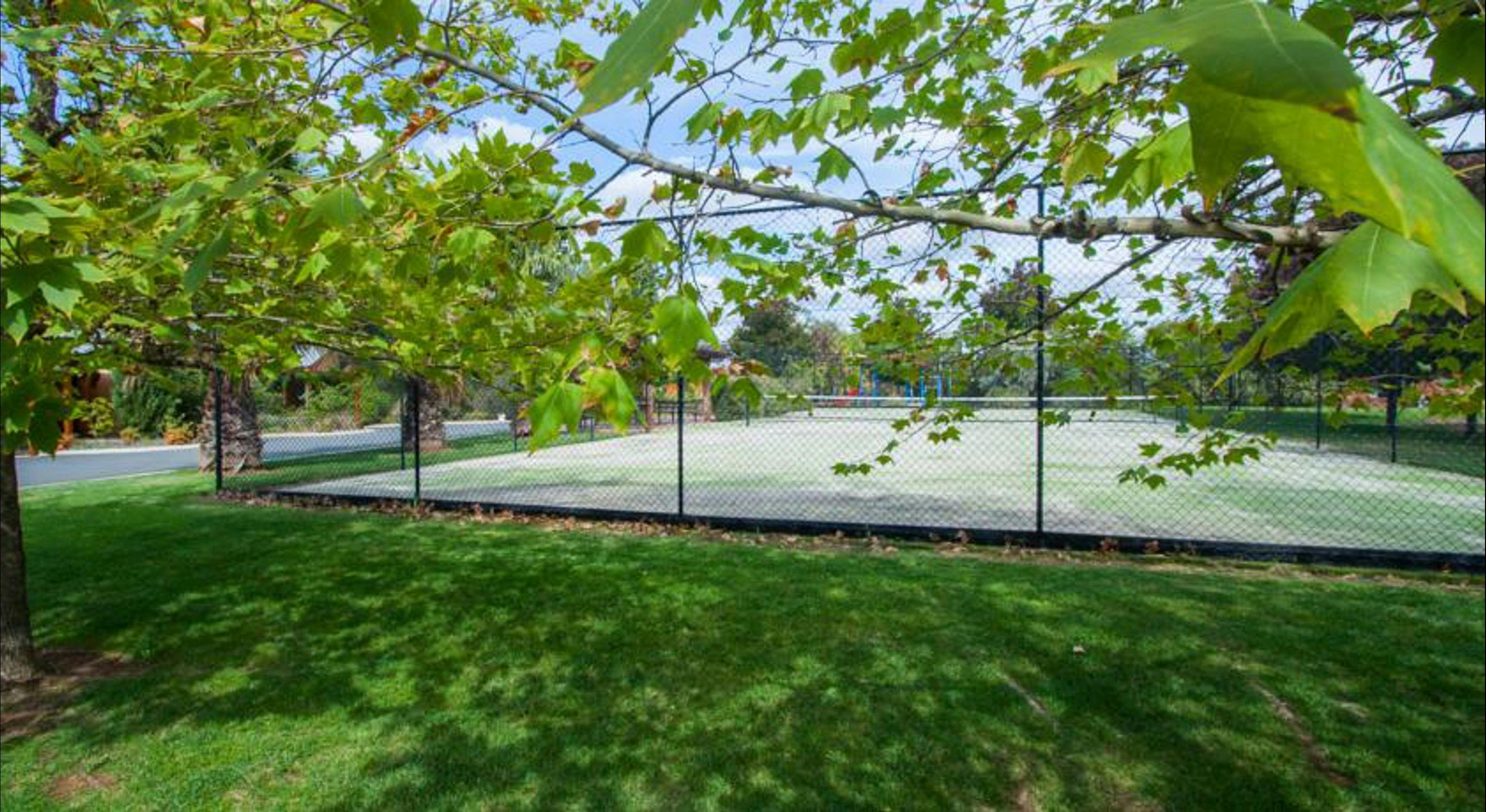 Tennis Court amongst landscape gardens