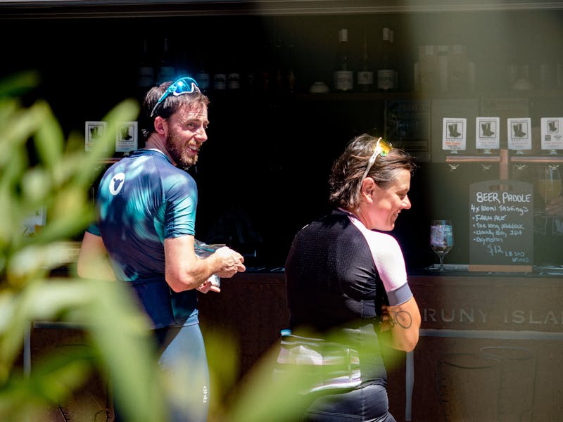 Two cyclists waiting to order some Bruny Island single malt