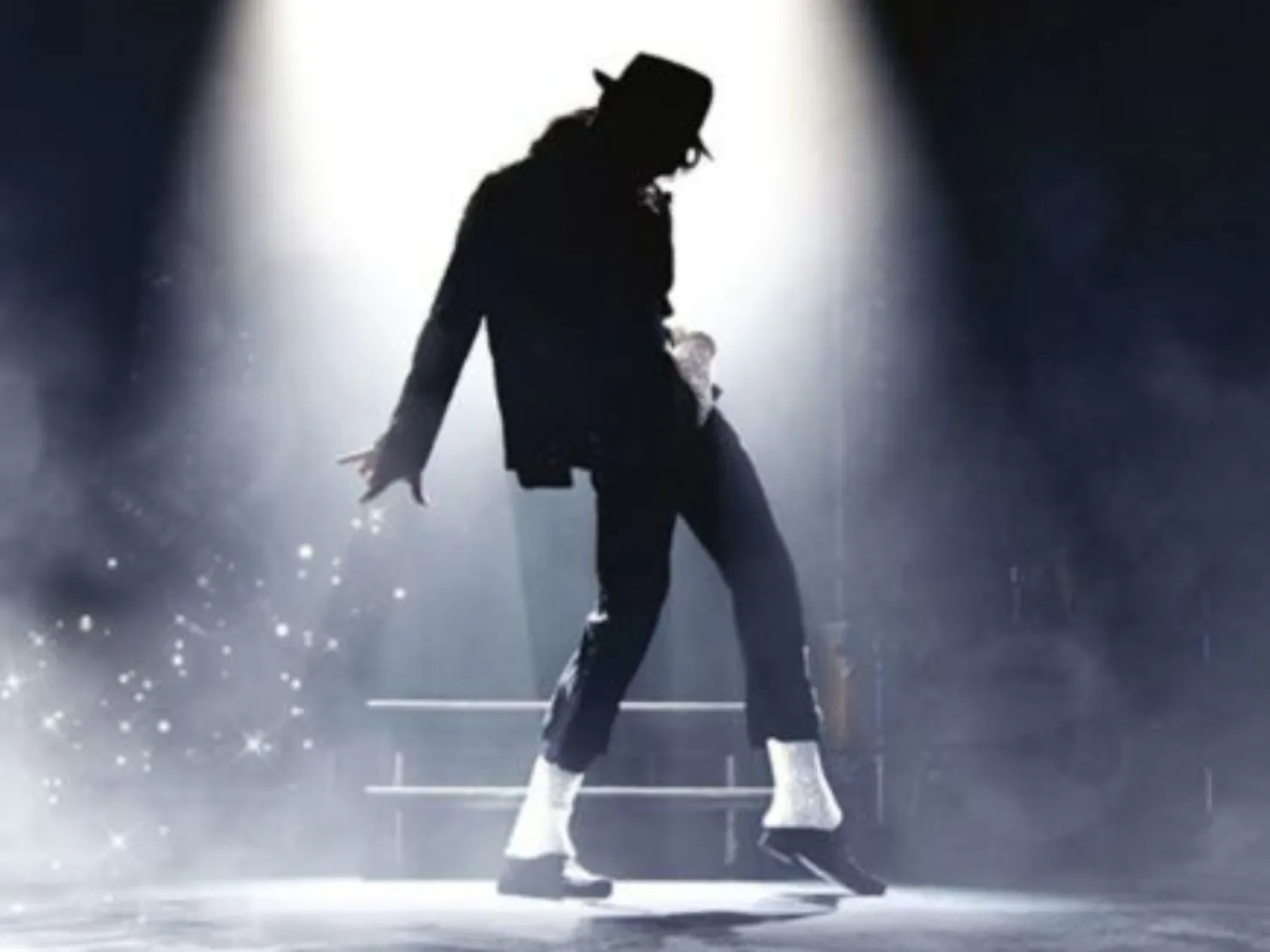 Spotlight on a silhouette of Michael Jackson with hat and white socks