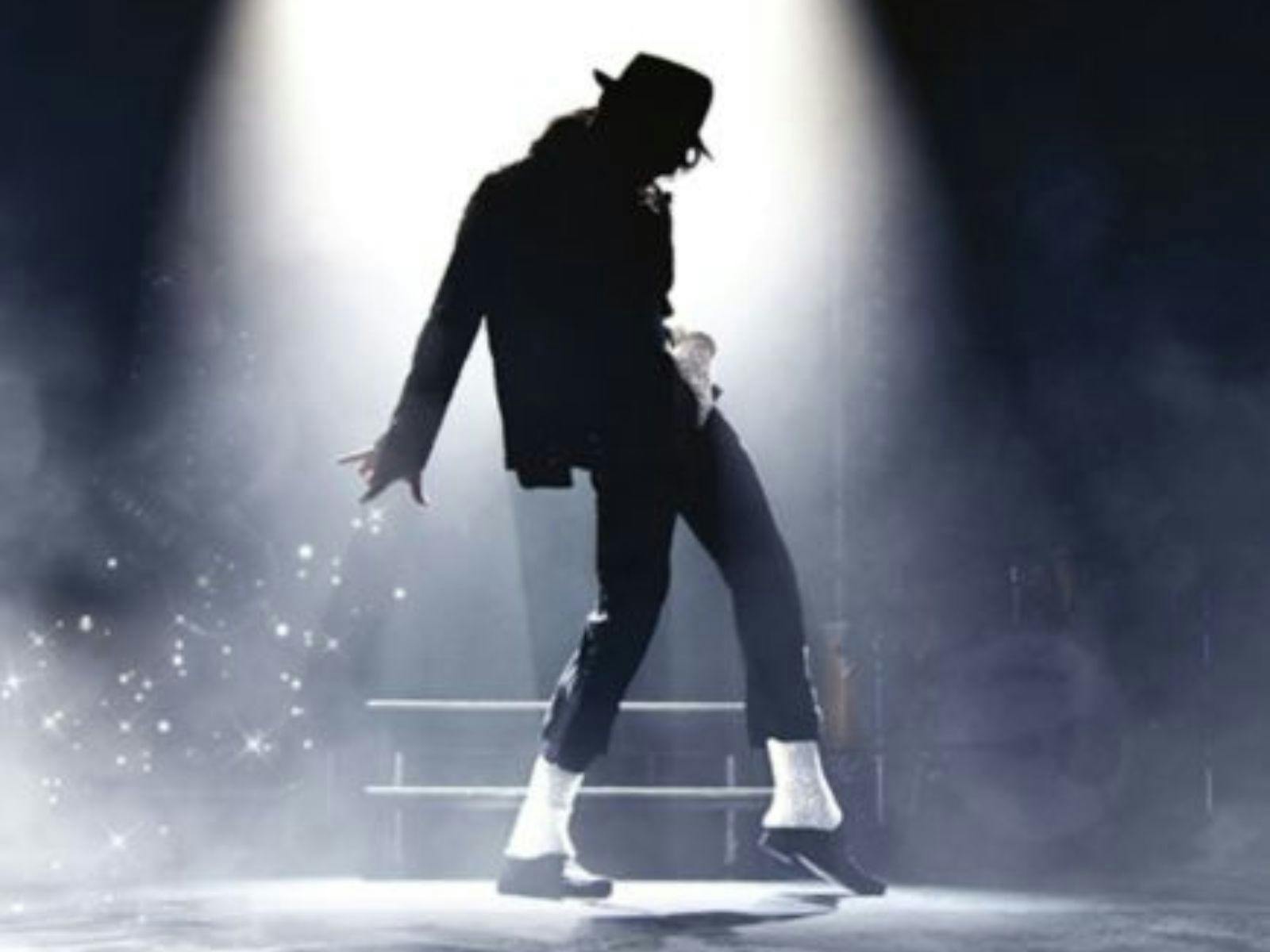 Spotlight on a silhouette of Michael Jackson with hat and white socks Spotlight on a silhouette of Michael Jackson with hat and white socks