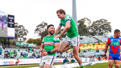 Canberra Raiders players Simi Sasagi and Jed Stuart celebrating a try.