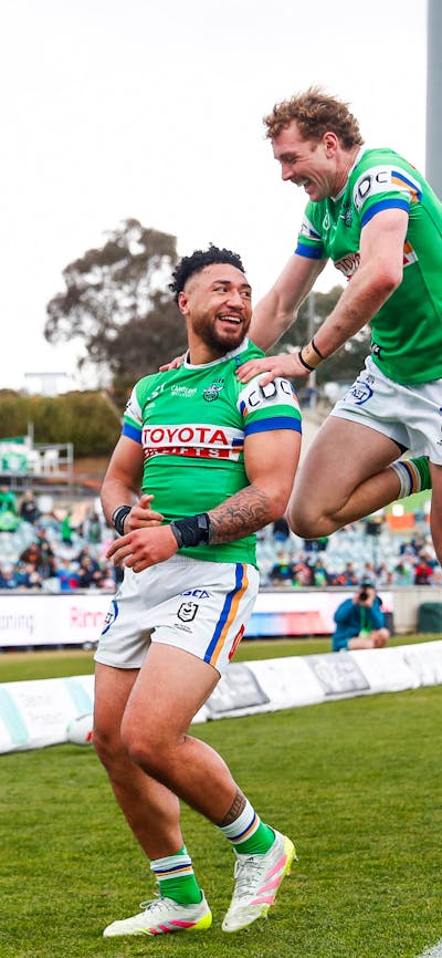 Canberra Raiders players Simi Sasagi and Jed Stuart celebrating a try.