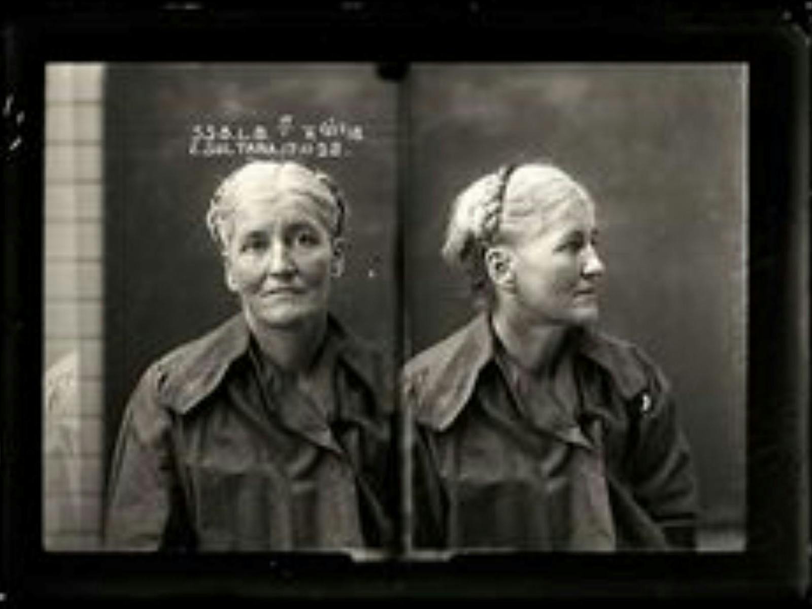 A very old black and white police photo of a blonde woman with braided hair. A very old black and white police photo of a blonde woman with braided hair.