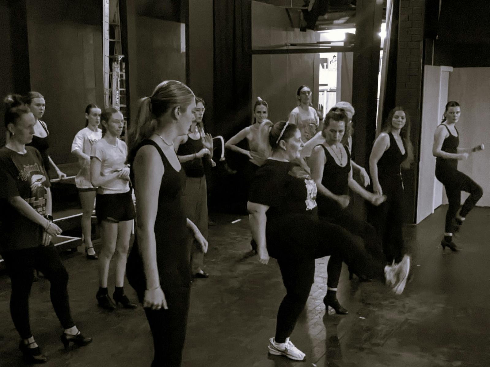 women wearing black dancing in black and white picture