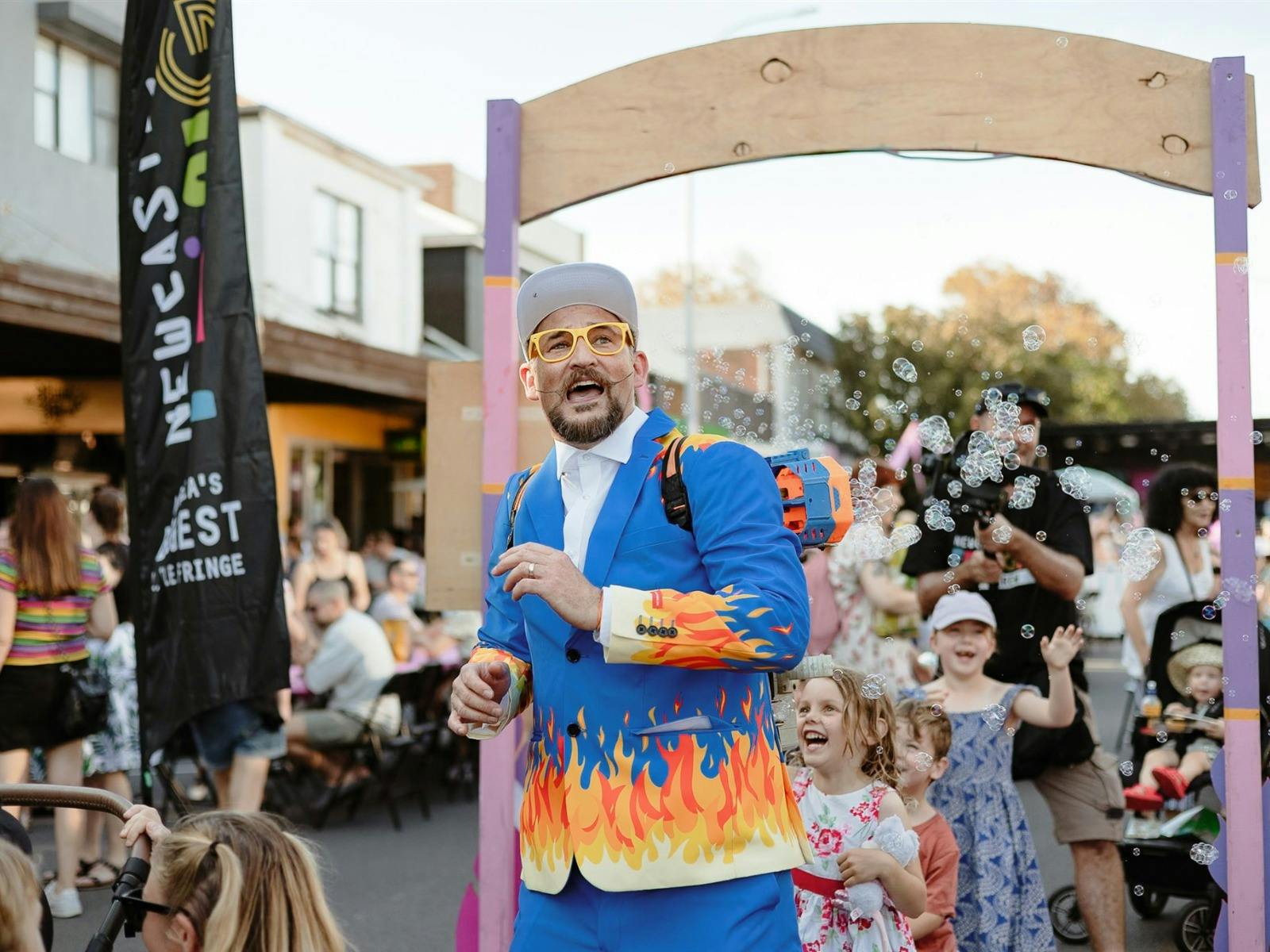 man wearing colourful suit followed by children
