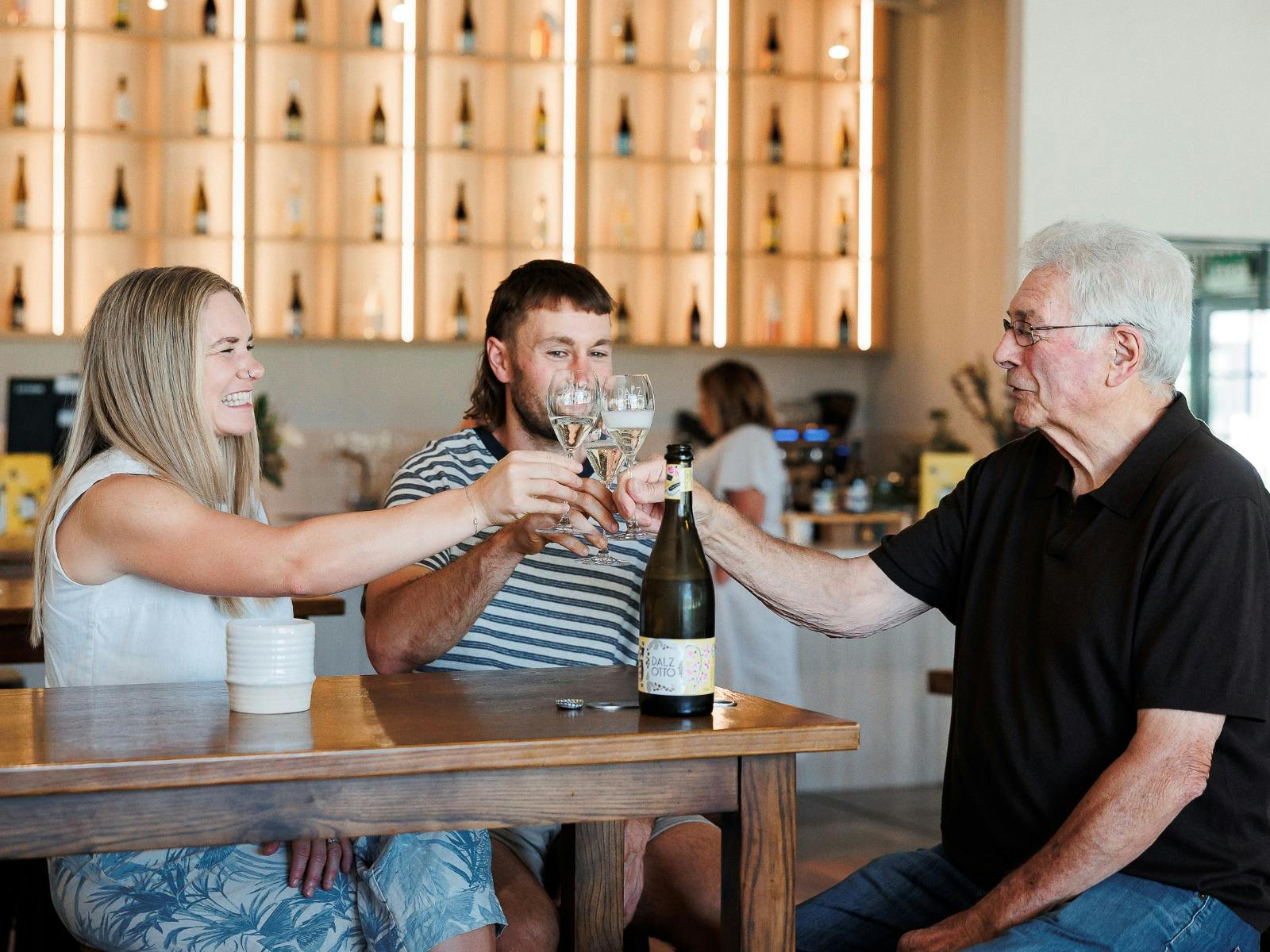 Group with Otto Dal Zotto Cheers in Cellar Door