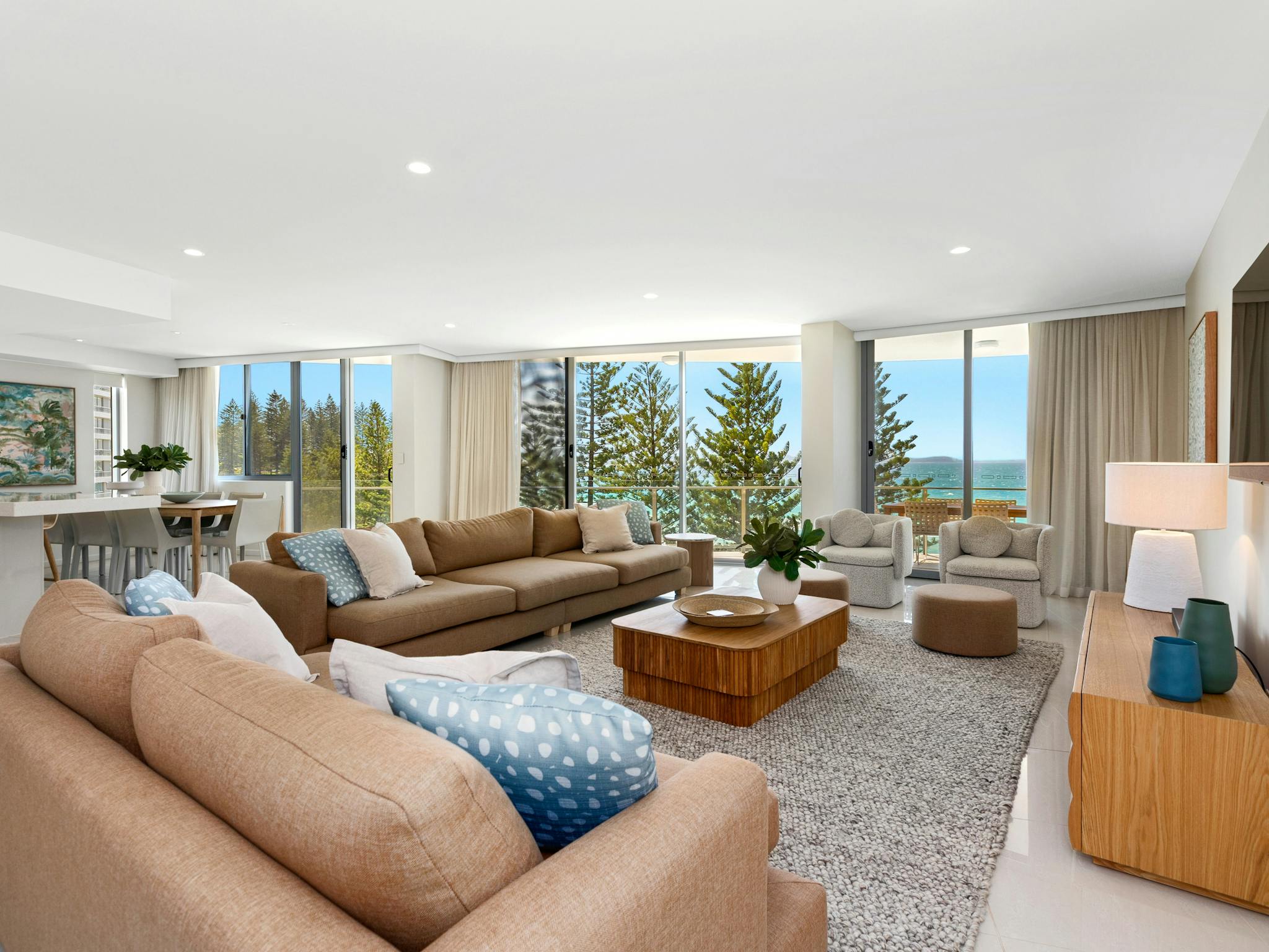 Warm, inviting lounge featuring two large tan lounges, elegant decor, and breathtaking ocean views Warm, inviting lounge featuring two large tan lounges, elegant decor, and breathtaking ocean views