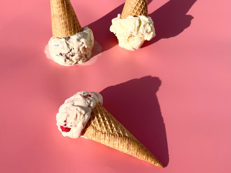 There’s ice-cream cones on a pink background