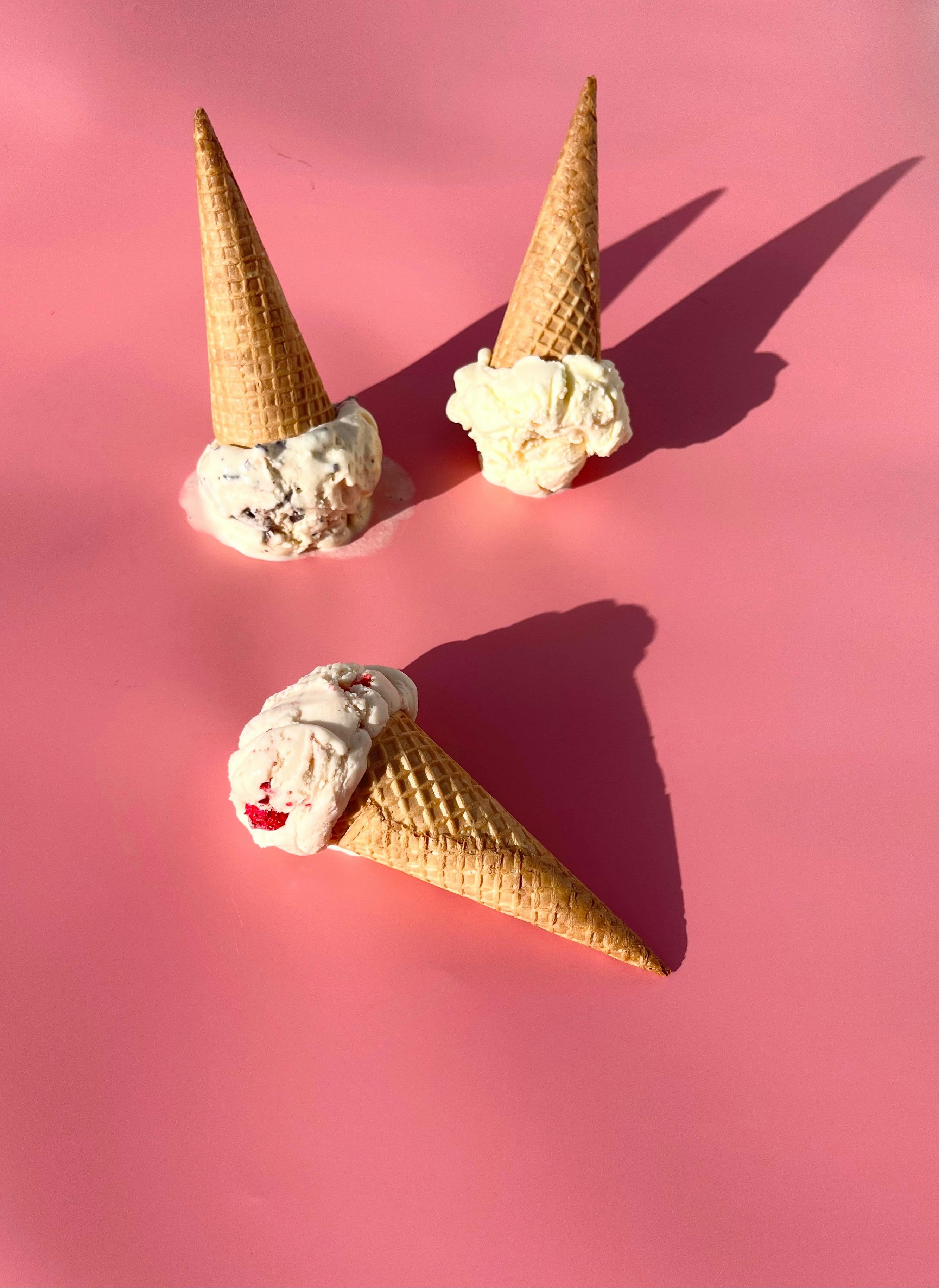 There’s ice-cream cones on a pink background