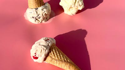 There’s ice-cream cones on a pink background