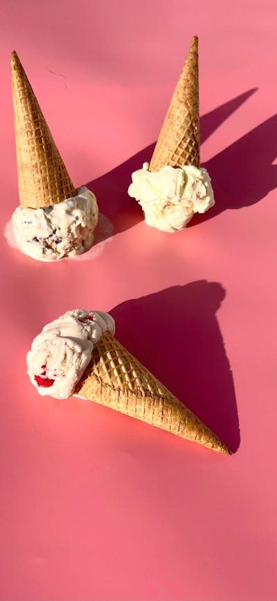 There’s ice-cream cones on a pink background