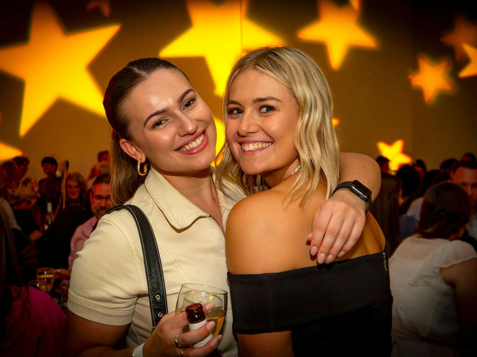 Girls at Christmas party with yellow star lights