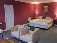 A king size bed in a red room