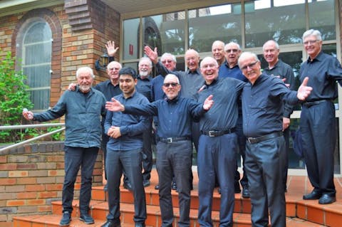 Members of the Chorale standing on steps
