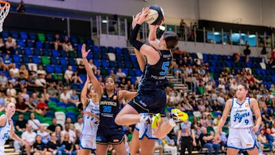UC Capitals player shooting the basketball while a defender closes in.