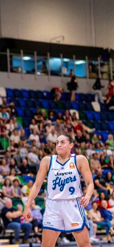 UC Capitals player shooting the basketball while a defender closes in.